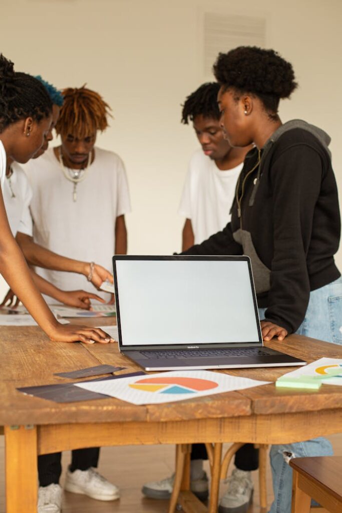 Crafting Captivating Headlines: Your awesome post title goes here Young professionals brainstorming and planning around a laptop for creative project.
